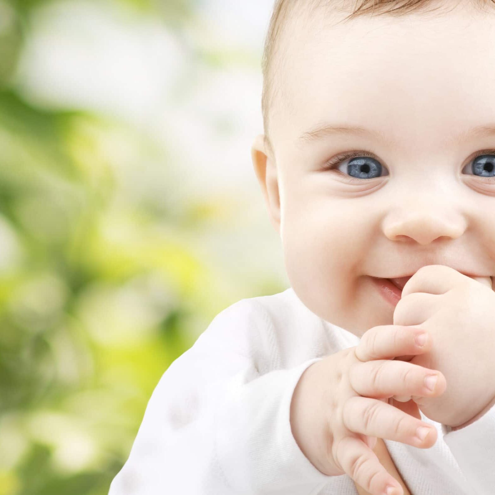 child, happiness and people concept - adorable baby
